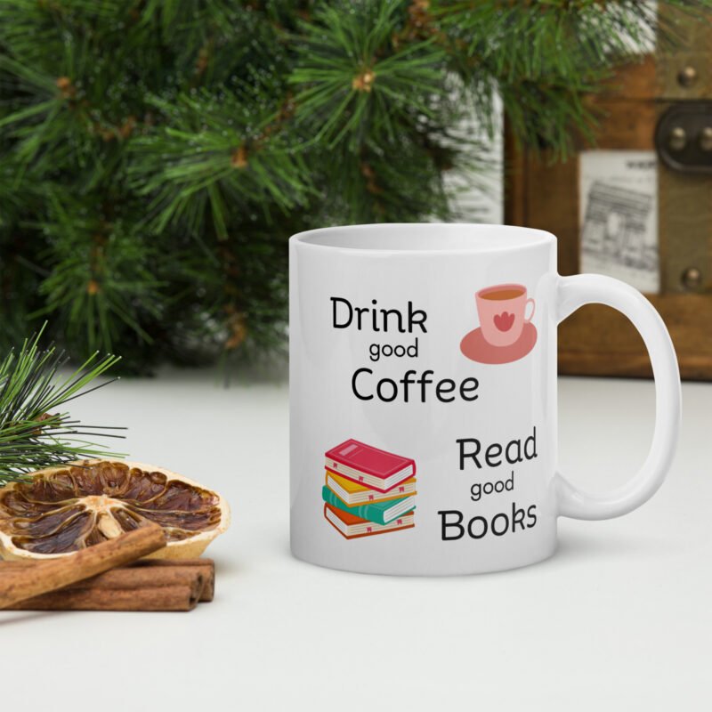 Coffee mug with text and pictures - Drink good coffee read good books - Ceramic white mug lying on flat surface - 11 oz